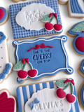 Decorative cookies with text and cherry designs on a white background